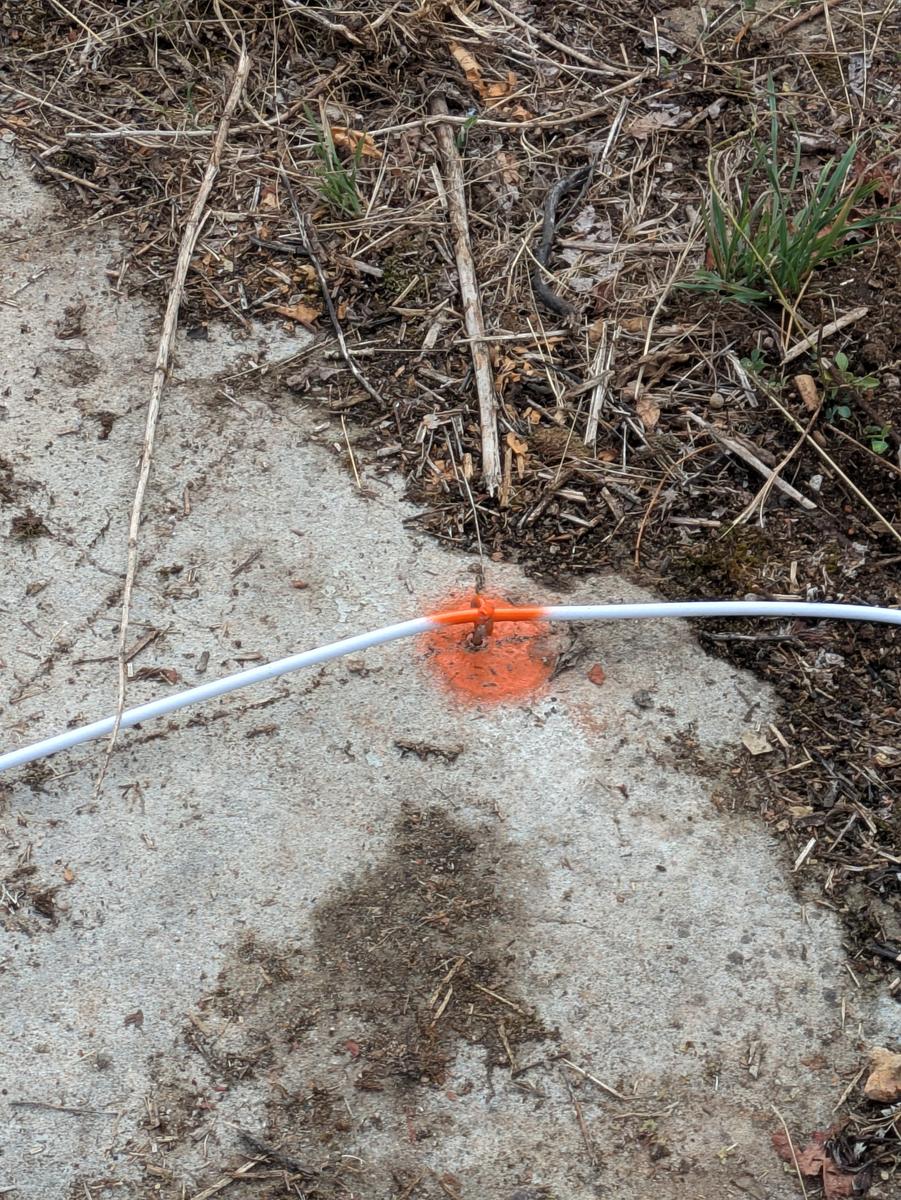 The cable crossing the rail, marked in orange paint