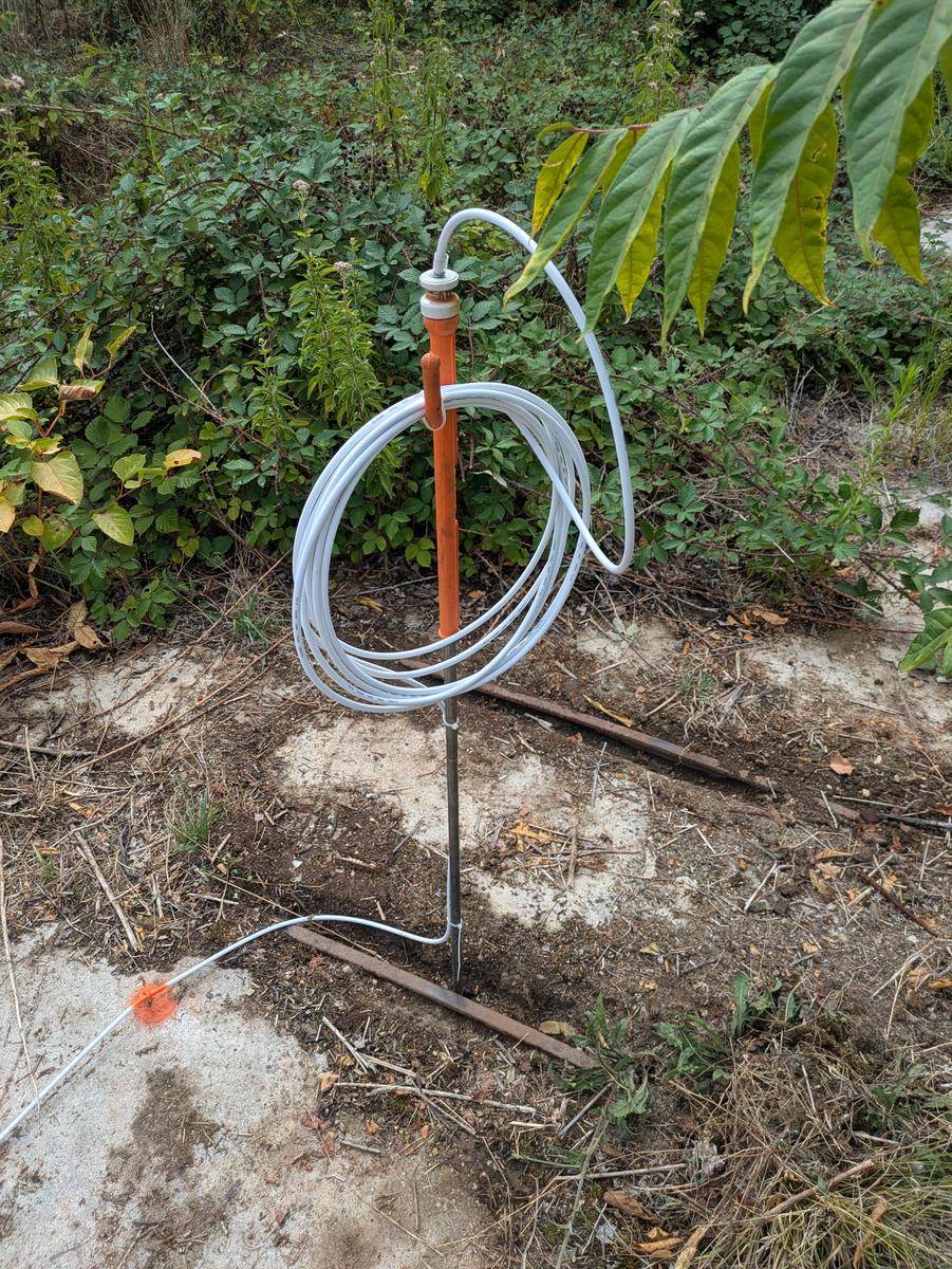 The earth spike, insulator and coiled surplus cable