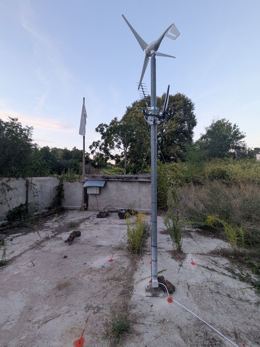 The NEUTRAL HOST mast at dusk, guyed to its ground anchors